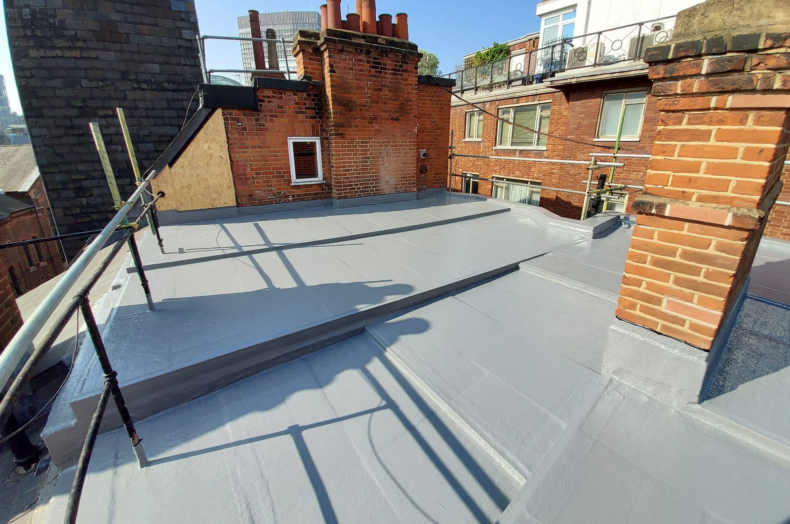 Finished flat roof between brick parapets